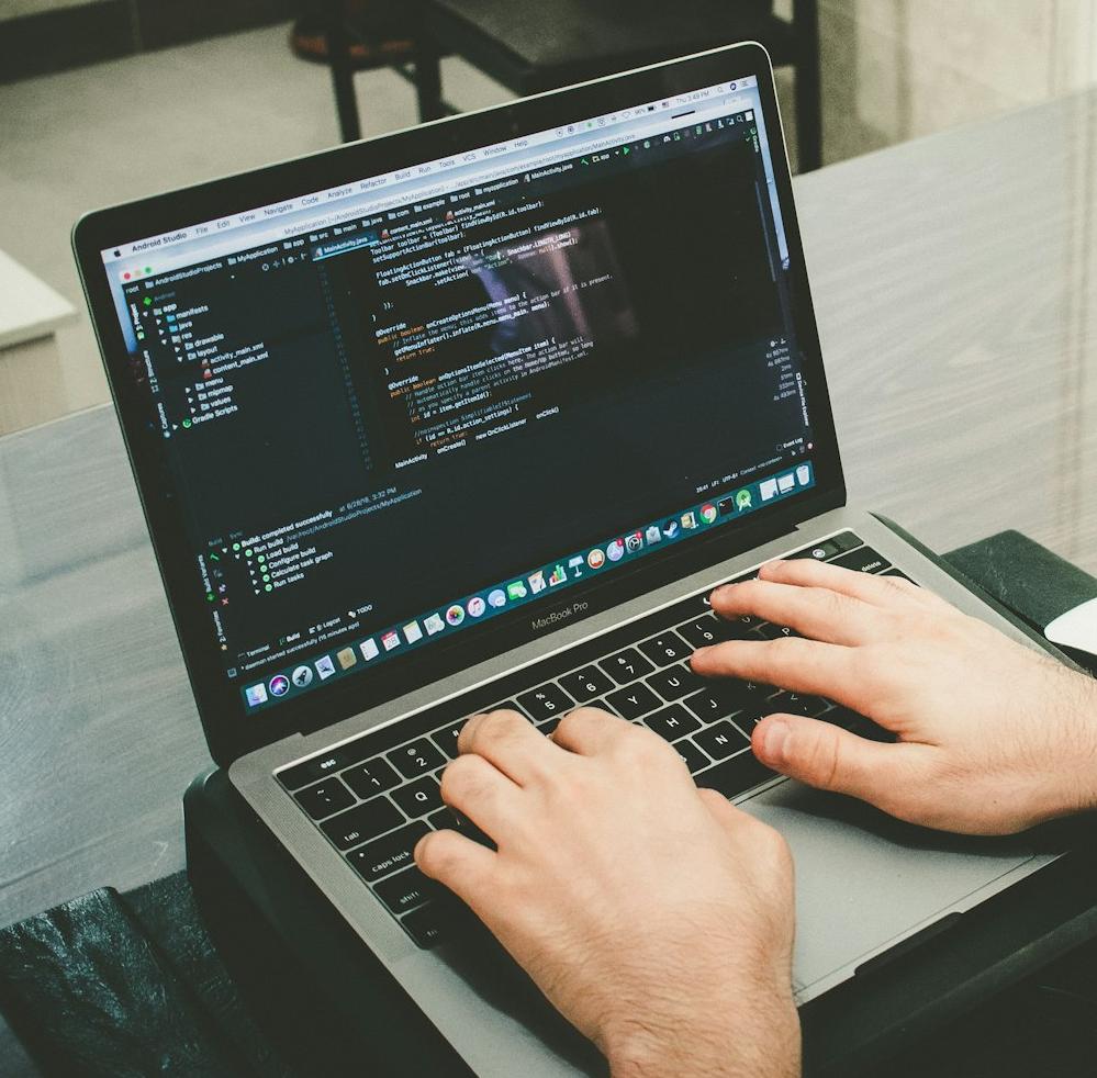 man programming using laptop